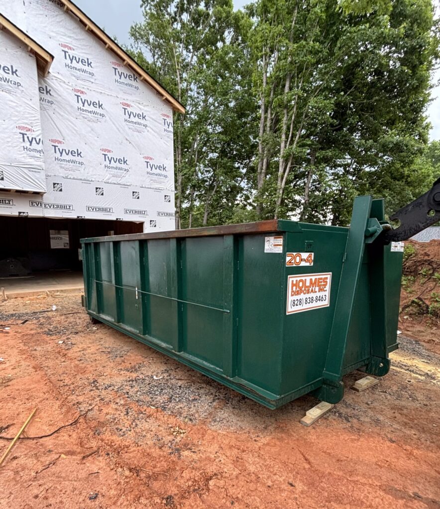 Green dumpster in front of house in Conover, NC