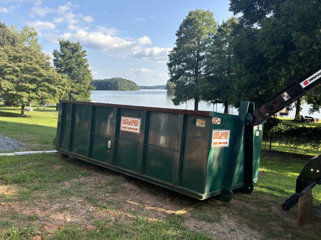 Green dumpster in Catawba, NC under a tree